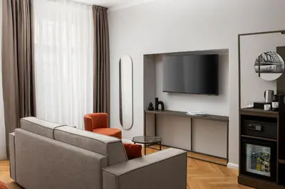 a living room with a couch and a tv at The Bridge Residence by Little King in Prague