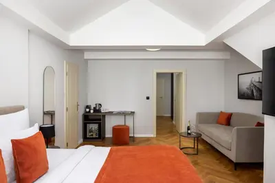a hotel room with a bed and a couch at The Bridge Residence by Little King in Prague