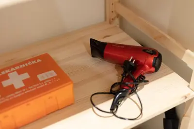 a red drill on a table next to a box at Large apartment Prosek - Your second home! in Prague