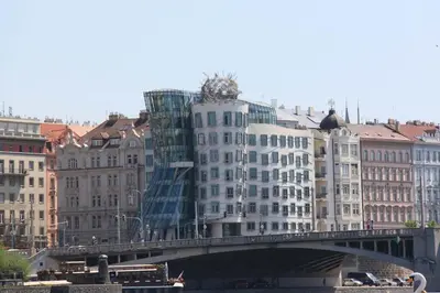 a bridge over a river with buildings on it at Large apartment Prosek - Your second home! in Prague