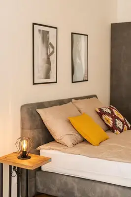 a bed with two pillows and a table in a room at LUXURY RESIDENCE APARTMENTS in VÁCLAVSKÉ NÁMĚSTÍ in Prague