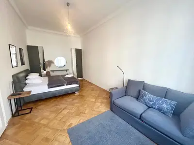a living room with a couch and a bed at LUXURY RESIDENCE APARTMENTS in VÁCLAVSKÉ NÁMĚSTÍ in Prague