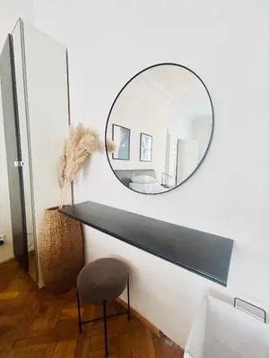a mirror on a wall with a desk and a chair at LUXURY RESIDENCE APARTMENTS in VÁCLAVSKÉ NÁMĚSTÍ in Prague