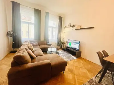 a living room with a couch and a tv at LUXURY RESIDENCE APARTMENTS in VÁCLAVSKÉ NÁMĚSTÍ in Prague