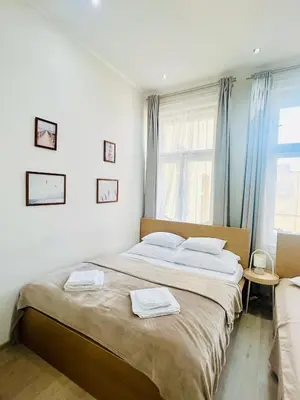 a bedroom with a large bed with two towels on it at LUXURY RESIDENCE APARTMENTS in VÁCLAVSKÉ NÁMĚSTÍ in Prague