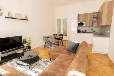 a living room with a couch and a table at LUXURY RESIDENCE APARTMENTS in VÁCLAVSKÉ NÁMĚSTÍ in Prague