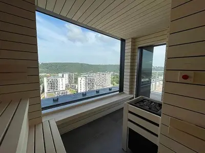 a large window with a view of a city at Luxe studio with pool, sauna, jacuzzi, gym, balcony in Prague