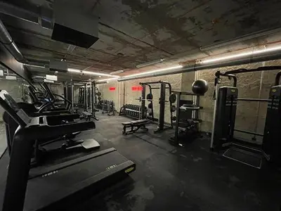 a gym with several treadmills and a treadmill at Luxe studio with pool, sauna, jacuzzi, gym, balcony in Prague