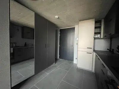 a room with a kitchen with a door in it at Luxe studio with pool, sauna, jacuzzi, gym, balcony in Prague