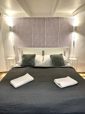 a bedroom with a large bed with two towels on it at Elly Modern Oldtown Apartments in Prague