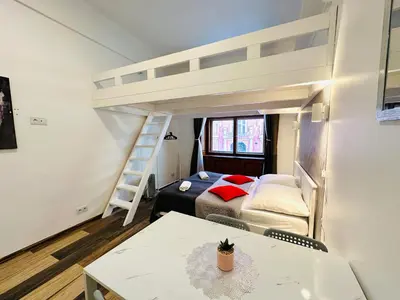 a small room with a bunk bed and a table at Elly Modern Oldtown Apartments in Prague