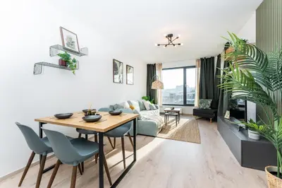 a living room with a table and a couch at Rentero One bedroom O2 Arena Dinopark Apartment in Prague