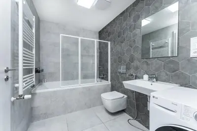 a bathroom with a toilet and a shower and a sink at Rentero One bedroom O2 Arena Dinopark Apartment in Prague