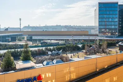 a view of a building with trees and buildings at Rentero One bedroom O2 Arena Dinopark Apartment in Prague