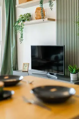a wooden table with two plates on top of a television at Rentero One bedroom O2 Arena Dinopark Apartment in Prague