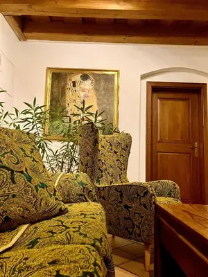 a living room with two chairs and a painting at Prague Romantic Apartment near Charles Bridge in Prague