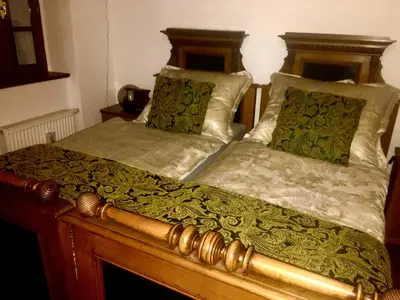 a bedroom with two beds with green and white sheets at Prague Romantic Apartment near Charles Bridge in Prague