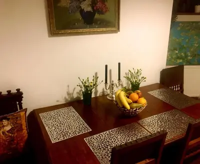 a dining room table with a bowl of fruit on it at Prague Romantic Apartment near Charles Bridge in Prague