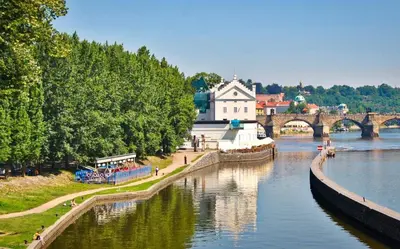 a view of a river with a building and a bridge at Prague Romantic Apartment near Charles Bridge in Prague