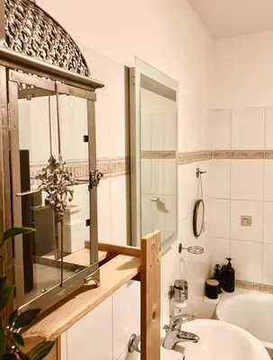 a bathroom with a sink and a mirror and a tub at Prague Romantic Apartment near Charles Bridge in Prague