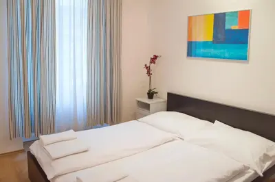 a bedroom with a bed and a window with a painting at Opatovicka affordable stay in Prague