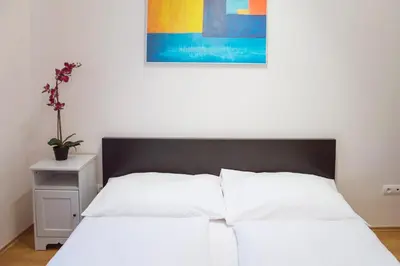 a white bed with a black headboard in a bedroom at Opatovicka affordable stay in Prague