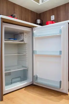 an empty refrigerator with its door open in a kitchen at Opatovicka affordable stay in Prague