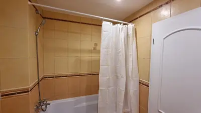 a shower with a white shower curtain in a bathroom at Opatovicka affordable stay in Prague