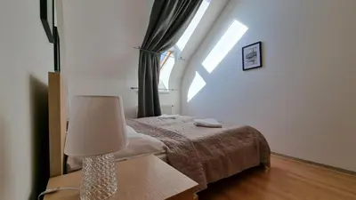a bedroom with a bed and a lamp on a table at Opatovicka affordable stay in Prague