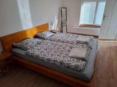 a bedroom with a bed with a wooden headboard at Bnest in Beroun