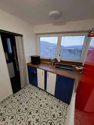 a red refrigerator in a kitchen with a microwave at Bnest in Beroun