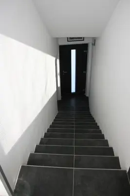 a hallway with stairs leading to a door at Bnest in Beroun