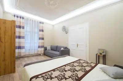 a bedroom with a bed and a couch in it at Navratilova Apartment in Prague