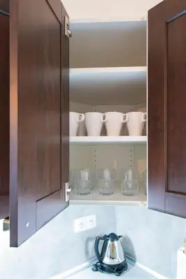 a kitchen cabinet with a tea kettle on a kitchen counter at Navratilova Apartment in Prague