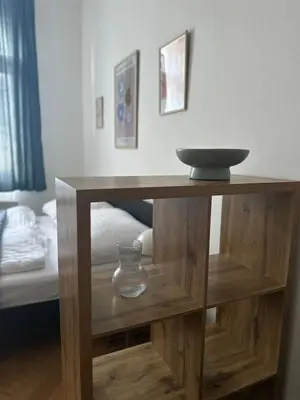 a wooden table with a bowl on top of it at Chic Retreat on Skorepka Street in Prague