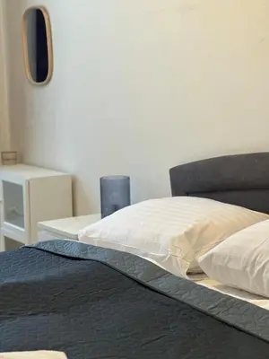 a bedroom with a bed and a table with a mirror at Chic Retreat on Skorepka Street in Prague