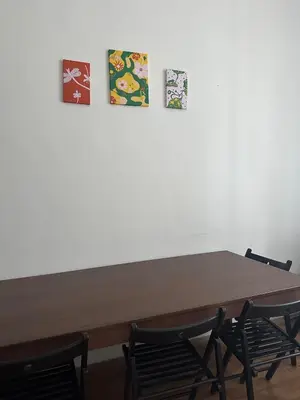 a wooden table with four pictures on the wall at Chic Retreat on Skorepka Street in Prague