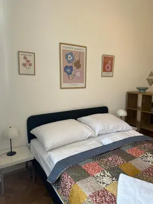 a bedroom with a bed with a quilt on it at Chic Retreat on Skorepka Street in Prague