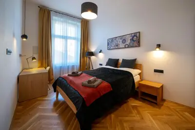 a bedroom with a large bed and a bathroom at OLD TOWN - 3 Room 2 Bathroom Balcony in Prague