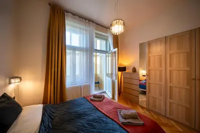 a bedroom with a bed and a large window at OLD TOWN - 3 Room 2 Bathroom Balcony in Prague