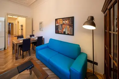 a living room with a blue couch and a table at OLD TOWN - 3 Room 2 Bathroom Balcony in Prague