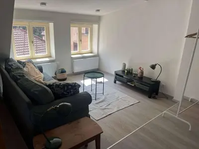 a living room with a couch and a table at Malebný byt pod hradem Křivoklát in Křivoklát