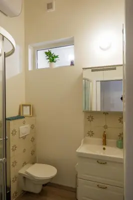 a bathroom with a toilet and a sink and a mirror at Malebný byt pod hradem Křivoklát in Křivoklát