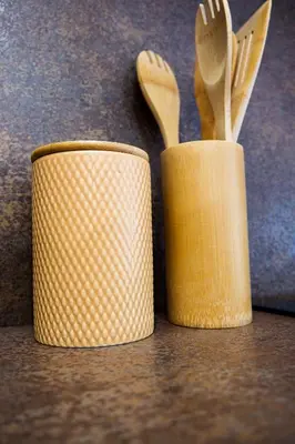two containers filled with wooden utensils on a table at Malebný byt pod hradem Křivoklát in Křivoklát