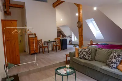 a living room with a couch and a table at Malebný byt pod hradem Křivoklát in Křivoklát