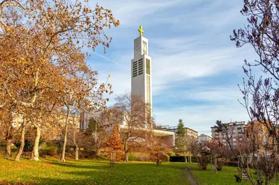 a tall building with a statue on top of it at Sunny luxury apartments Grebovka in Prague