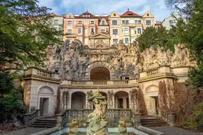 a building with a fountain in front of a castle at Sunny luxury apartments Grebovka in Prague
