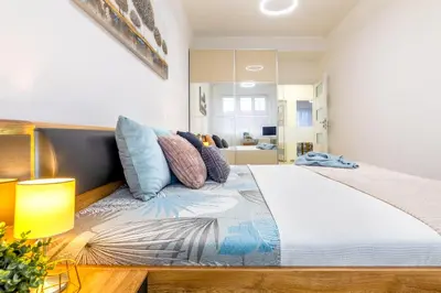 a bedroom with a large bed with pillows on it at Sunny luxury apartments Grebovka in Prague