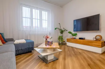 a living room with a couch and a flat screen tv at Sunny luxury apartments Grebovka in Prague