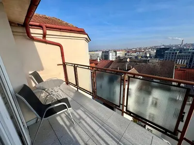a balcony with a table and chairs on a building at Cozy Studio with Prague panorama view in Prague